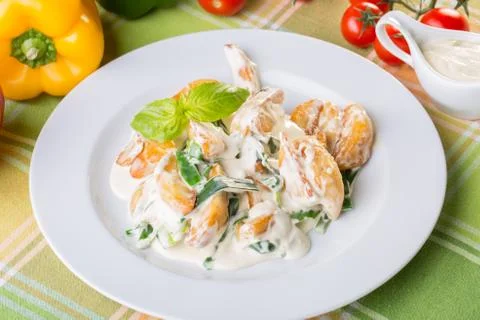 Close up of potatoes with white sauce and onions Stock Photos