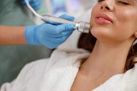 Close up potrait of female client getting aesthetic face skin treatment in Foto stock