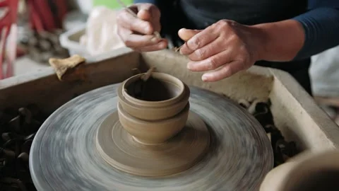 Close up of a potter creating a clay bowl on a rotating pottery wheel. Crafting Stock Footage 325972660