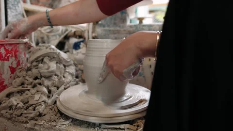 Close up of potter hands shaping clay pot on a spinning pottery wheel in a .. Video stock 336979920