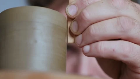 Close-up. potter processes the edges of a clay teapot on a potter's wheel Stock Footage 145534584