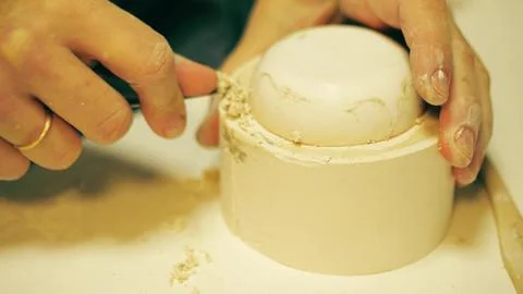 Close up of potter refining the edge of a plaster slip casting mold with a knife Stock Photos
