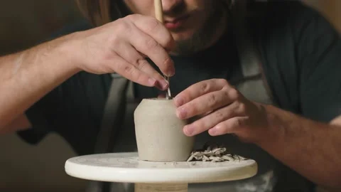 Close up of potter using tools to making ceramic clay cup in potter studio Video stock 233295296