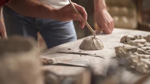 A close-up of potter working with ceramics clay using special tool and teaching Stock Footage 113080100
