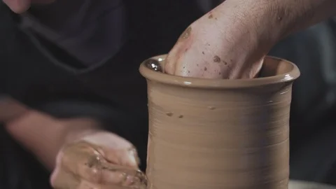 Close up of potter working with clay on potter's wheel. Man gently create jug Stock Footage 107826788