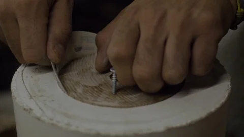 Close-up of a potter's hand grinding a hypostatic template with a wooden blank Stock Footage 118087774