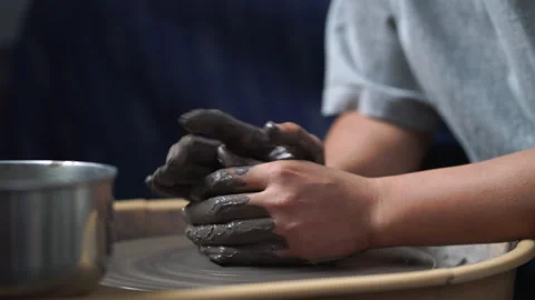 Close-up of potter's hands covered with clay making beautiful vase Stock Footage 150684835