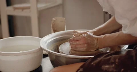 Close-up of potter's hands covered with clay making beautiful vase on throwing Stock Footage 207070062