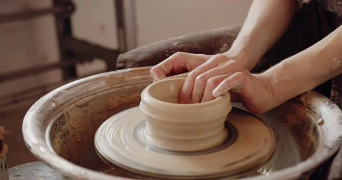 Close-up of potter's hands covered with clay making beautiful ware on throwing Stock Footage 207070268