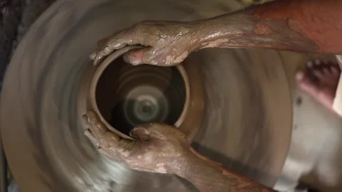 Close-up of potters hands shaping clay on a spinning wheel, traditional pot.. Stock-Footage 335119690