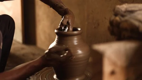 Close-up of potters hands shaping clay on a spinning wheel, traditional pot.. Stock Footage 335119693
