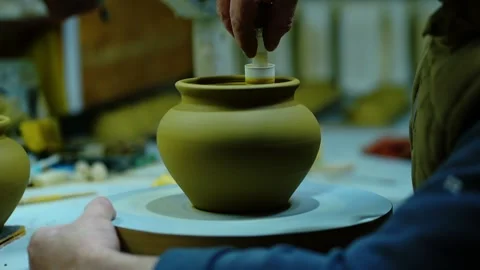 Close-up of a potter's hands using a specialized smoothing tool. Stock Footage 328925407
