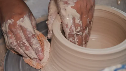 Close up of pottery making hands with sponge in indoor workshop, Malaysia Stock Footage 146565733