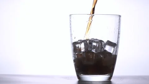 Close up of pour cola on ice cube in glass isolated Stock Footage 161109215