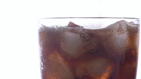 Close up of pour cola on ice cube in glass isolated Stock Footage 161109223
