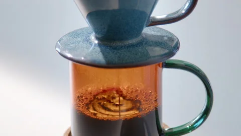 Close-up of pour-over coffee brewing on a white table Stock Footage 337323269