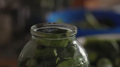 Close-up, Pouring Boiling Water into a Jar of Cucumbers for Marinade Preparation Stock Footage 157677984