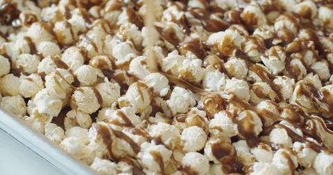 Close up pouring caramel melts down on mushroom popcorn, Slow Motion, 4K Stock Footage 108533512