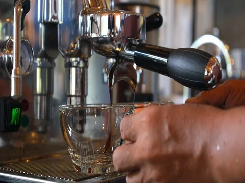 Close Up Of Pouring Coffee From Coffee Machine In Glass Cup Stockbeeldmateriaal 77188428