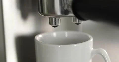 Close up of pouring coffee stream from machine in cup. Home making hot Espresso Stock Footage 196728474