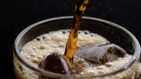 Close-up of Pouring Cola with ice in slow motion. Stock Footage 126194975