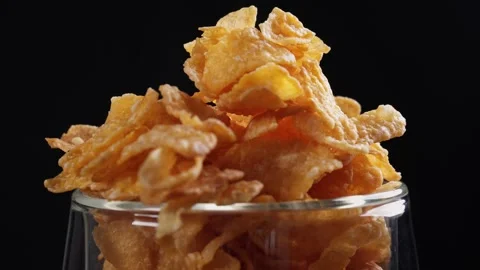 Close up of pouring corn flakes into empty clear glass Stock Footage 279700526