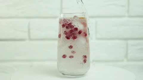 Close up pouring fresh clean drinking water into glass, splashing in glass on Stock Footage 271598914