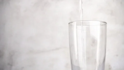 Close up pouring fresh water into a glass, Slow motion. Stock Footage