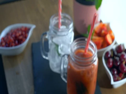 Close-up of pouring fruit smoothie into drinking glass Video stock 76633617