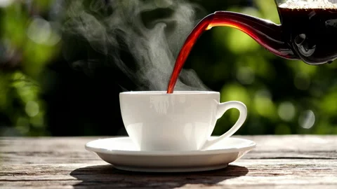 Close-up pouring hot coffee with steaming smoke, slow motion Video stock 205533439