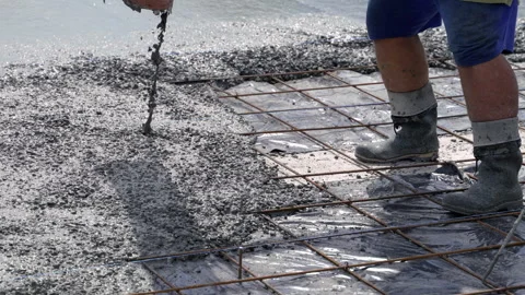 Close-up of pouring liquid cement mixture with crushed stone onto the floor 스톡 동영상 312382002