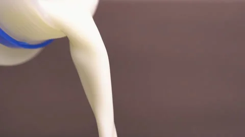 Close-up pouring milk from a bottle Stock Footage 196972896