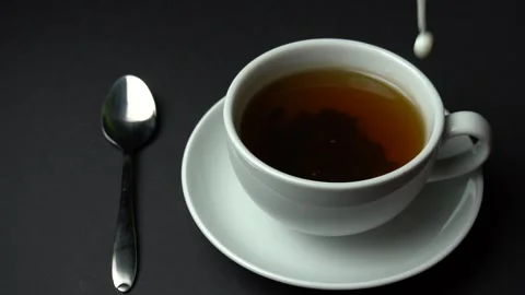Close up of Pouring Milk into a Cup of Tea. Slow Motion. Stock Footage 85643067