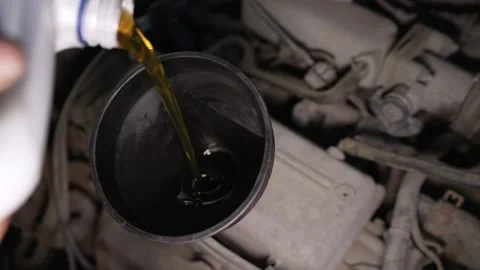 Close-up of pouring oil into a car engine. The process of pouring engine oil 스톡 동영상 156822798