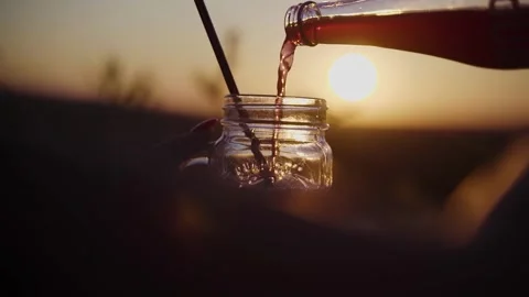 Close up Pouring Red Drink at Sunset girl hands Stock Footage 312686959