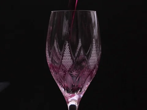 Close-up of pouring red wine from bottle into wine glass in super slow motion. Stock Footage 124514096