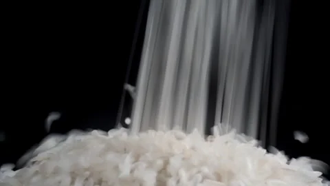 Close up of pouring rice isolated black background 库存影片 277682315