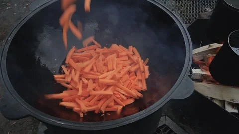 Close up pouring sliced carrots into a cauldron. Stock Footage 169883283