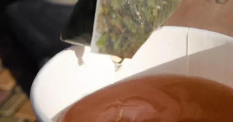 Close-up of pouring sugar from a packet into tea Stock Footage 345919161