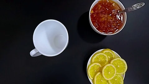 Close-up of pouring tea in white mug, slow motion hd video, top view Stock Footage 73774590