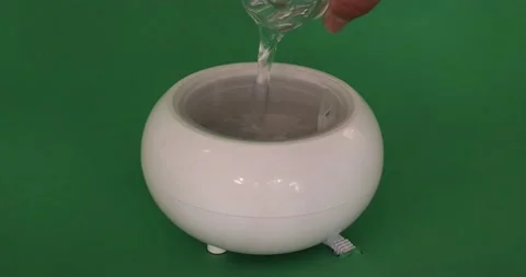 Close-up of pouring water and essential oil into a aroma oil diffuser humidifier Video stock 201268385