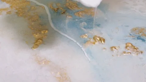 Close-up of pouring white-colored paint on the canvas. mixing acrylic paints Stock Footage 201389069