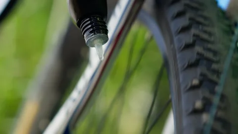 Close-up POV camera bicycle chain lubrication, bike maintenance in cycling Stock Footage 253408809