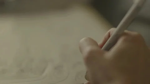 Close-up POV of hand drawing on notepad Stock Footage 334050017