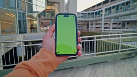 Close-Up POV Man Using Vertical Green Screen Phone - City Skyline View Stock Footage 309476429