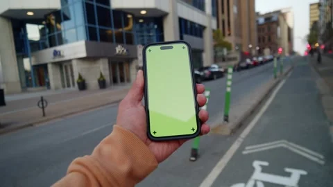 Close-Up POV Urban Tech: Man With Green Screen Phone On Night City Street Video stock 309475350