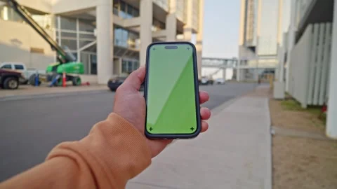 Close-Up POV Vertical Green Screen Phone In Hands - City Glow Scene Stock Footage 309475370