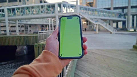 Close-Up POV Vertical Green Screen Phone - Man Holds In Big City Stock Footage 309476115