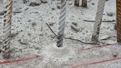 Close-up of power drill boring a hole into a concrete ceiling slab Stock Footage 333248946