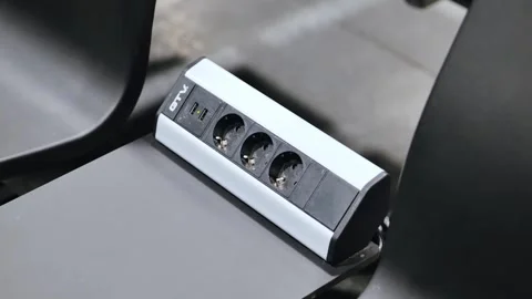 Close Up Power Outlet Strip With USB Ports On Table In Modern Waiting Area Stock Footage 334705952